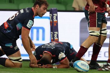 Melbourne Rebels players react to another Queensland Reds try.