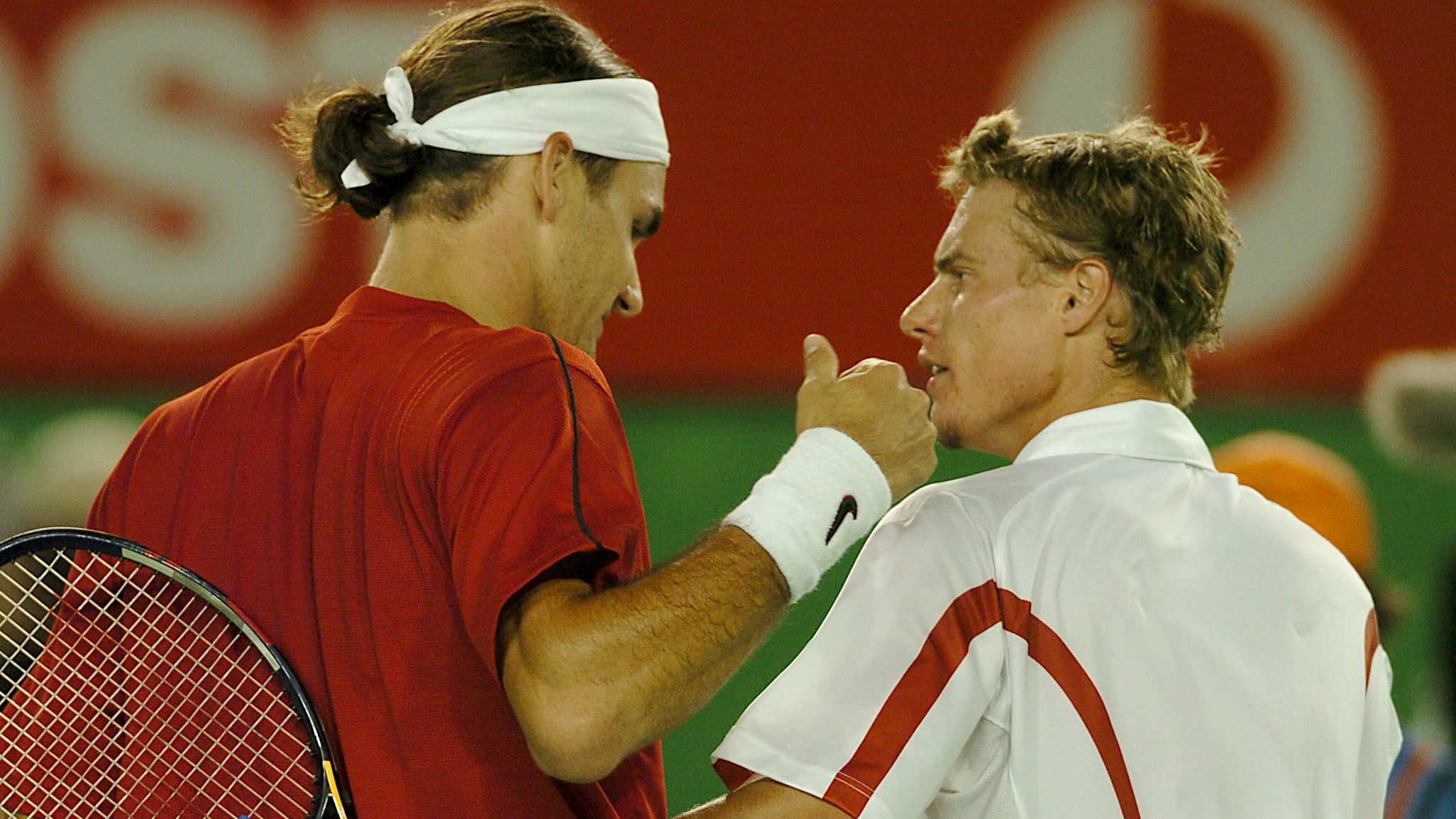 Roger Federer is congratulated by  Lleyton Hewitt after his win  (Photo by Jon Buckle/EMPICS via Getty Images)
