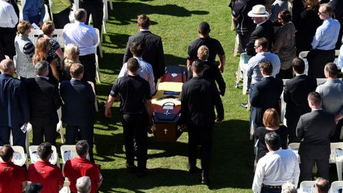 The coffin of Sunshine Coast footballer James Ackerman is carried into Sunshine Coast Stadium. (AAP)