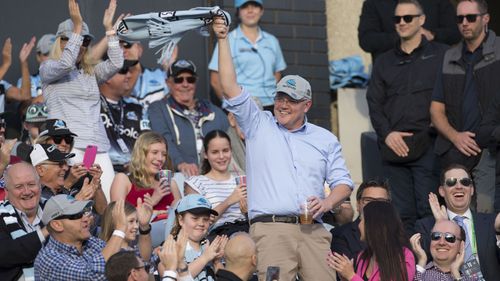 Newly reelected Prime Minister Scott Morrison waves to the crowd during the match between the Cronulla Sharks and the Manly Sea Eagles.