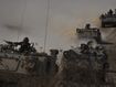 Israeli APCs head toward the Gaza Strip border in southern Israel on Friday, Oct.13, 2023. (AP Photo/Ariel Schalit)