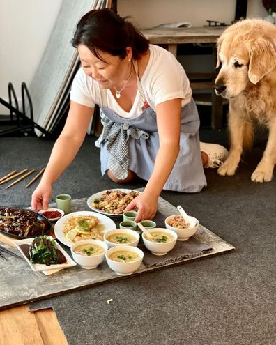 Nagi Maehashi with her dog Dozer as she sets up a food shoot.
