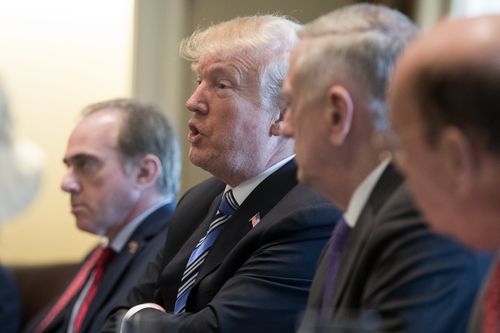 Mr Trump speaks beside US Secretary of Veterans Affairs David Shulkin (L) and other members of his Cabinet during a meeting in the Cabinet Room of the White House. (AP)