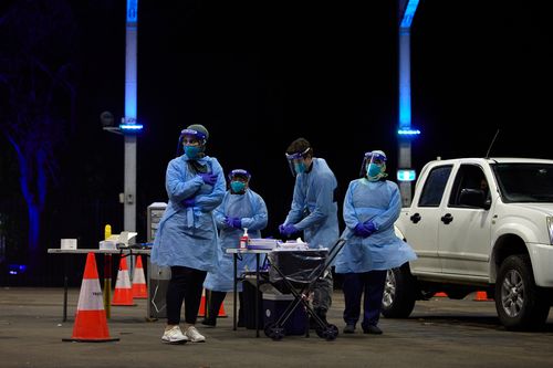 Nurses at a testing clinic in Sydney test for new coronavirus cases.