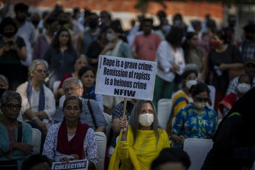 A woman holds a placard during a protest against remission of sentence by the government to convicts of a gang rape of a Muslim woman, in New Delhi, India, Saturday, August 27, 2022. 