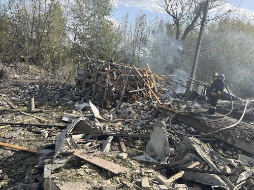 In this photo provided by the Ukrainian Presidential Press Office, emergency workers search the victims of a Russian rocket attack that killed at least 47 people in the village of Hroza near Kharkiv, Ukraine, Thursday, Oct. 5, 2023.