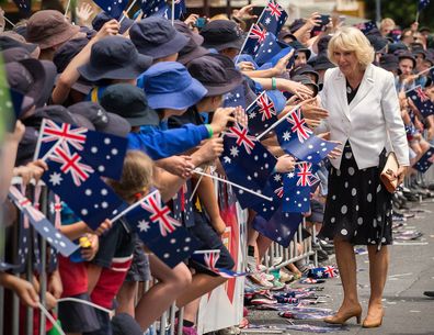 Camilla, Duchess of Cornwall, is greeted by flag-waving children in Tanunda, in the Barossa Valley area of Australia, Tuesday, Nov. 10, 2015.
