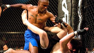 Cedric Marks (blue) punches Brandon McDowell during the Xtreme Fight Championship Texas Battle Grounds Warzone Series in 2009.