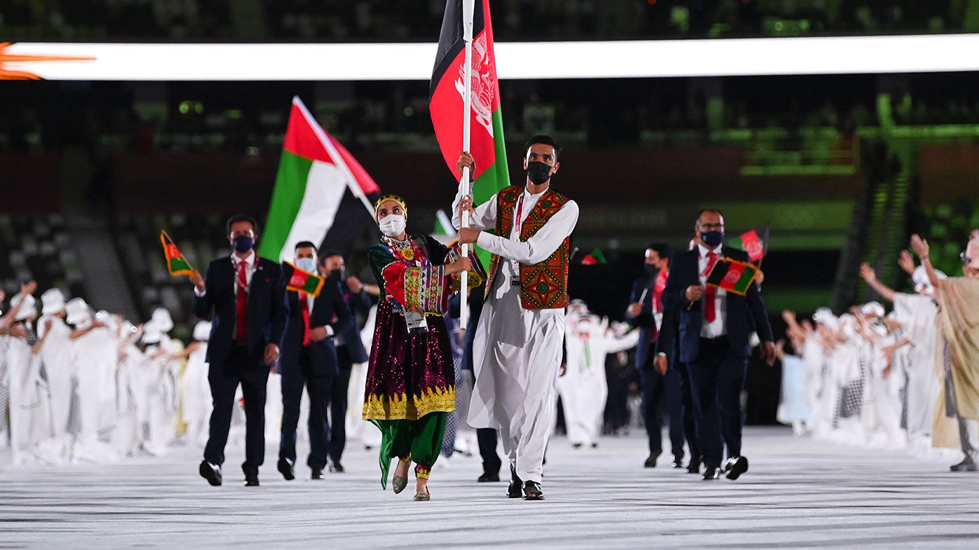 Flag bearers Kimia Yousofi and Farzad Mansouri of Team Afghanistan during the Opening Ceremony of the Tokyo 2020 Olympic Games at Olympic Stadium on July 23, 2021 in Tokyo, Japa