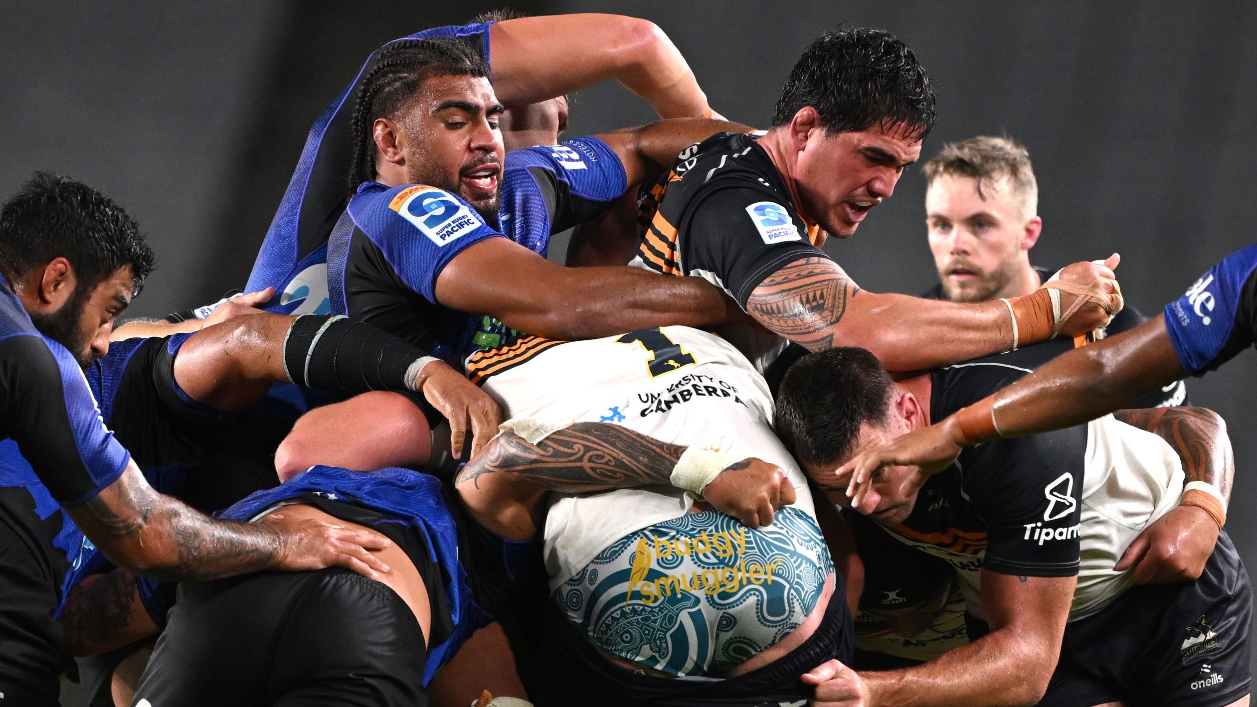 Hoskins Sotutu of the Blues tackles Darcy Swain of the Brumbies.