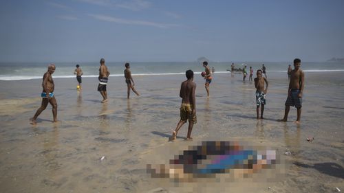 Outrage as images surface of beachgoers playing football next to corpses after Rio de Janeiro cycleway collapse 
