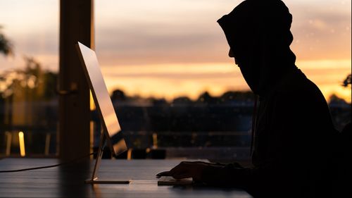 Scammer hackers laptop cybercrime online criminals