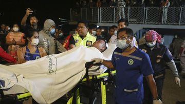 A rescued sailor from HTMS Sukhothai corvette is transferred on land at the Bangsaphan deep port in Prachuap Khiri Khan province, Thailand Monday, Dec. 19, 2022.