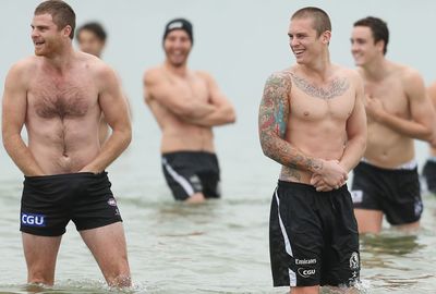 Plenty of his Magpies teammates also love the ink, including Dane Beams (R). (Getty)