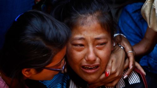 A Nepalese woman calls out in distress after the avalanche killed 16 guides last year. (AAP)