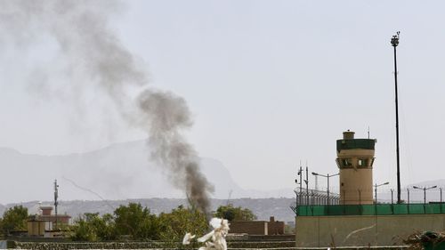 Smoke billows from the scene after six rockets were fired near Kabul airport (EPA/HEDAYATULLAH AMID).