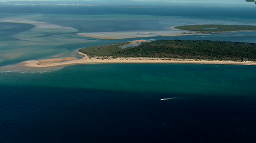 The pair took on water after travelling through dangerous conditions near north Stradbroke Island. 