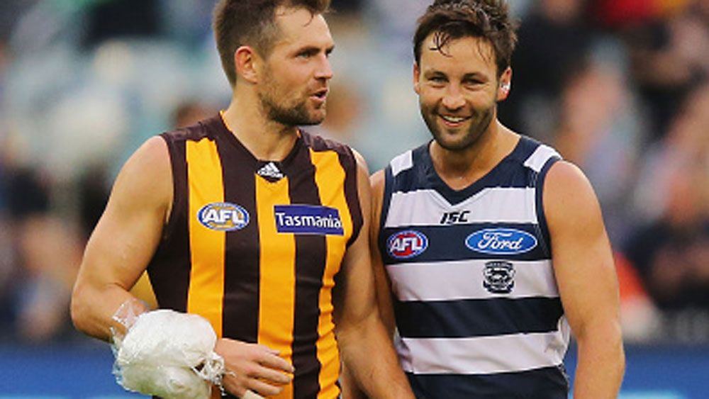 An iced-up Luke Hodge speaks with Jimmy Bartel after the loss. (Getty)