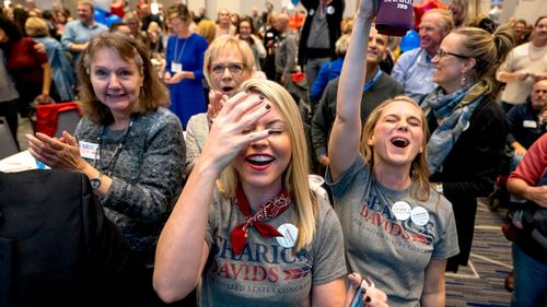 Supporters of Democratic House candidate from Kansas Sharice Davids cheer and cry after learning she has won her race at her election night watch party at the Embassy Suites Hotel in Olathe, Kansas.