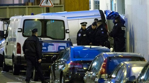 Police officers remove the bodies of slain Charlie Hebdo magazine staff members, including the chief editor and a number of cartoonists. (AAP)