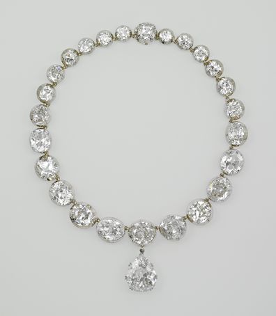 The Coronation necklace is a platinum, gold and silver set diamond necklace of twenty-five graduated cushion-shape brilliant cut diamond sets, cut-down and numbered silver collets with gold spiral links and a central drop-shape pendant. It is on display among other jewels in the Platinum Jubilee exhibition at Windsor Castle