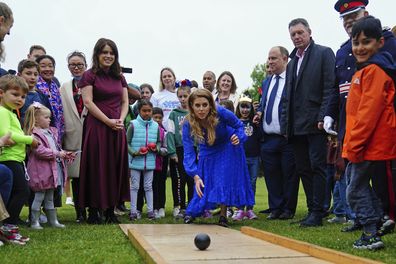 Princess Beatrice, centre, and Princess Eugenie play on the bowling alley during the Big Jubilee Lunch organized by Westminster Council 