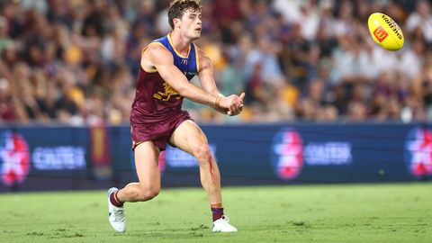BRISBANE, AUSTRALIA - MARCH 24: Josh Dunkley of the Lions handballs during the round two AFL match between Brisbane Lions and Melbourne Demons at The Gabba, on March 24, 2023, in Brisbane, Australia. (Photo by Chris Hyde/Getty Images)