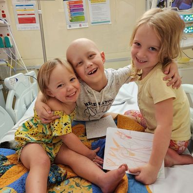 Ollie Jepson in hospital with his two sisters during cancer treatment.