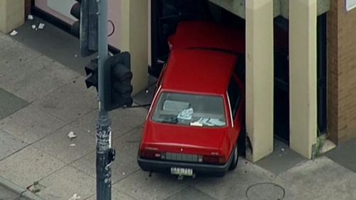 The driver crashed into the Westpac Bank branch after colliding with another car. (9NEWS)