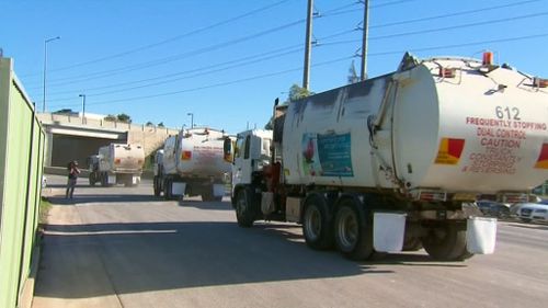 The convoy of trucks head for SBS headquarters in Artarmon. (9NEWS)