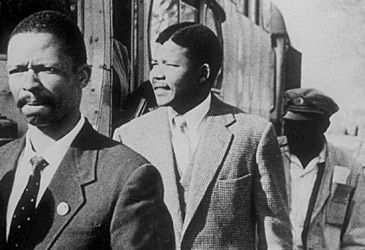 Nelson Mandela was charged but found not guilty of which crime in 1956?