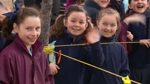 Children from local schools cheered as the much-needed hay was brought to their town.