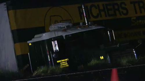 The 52-year-old semi-trailer driver was treated for shock. (9NEWS)