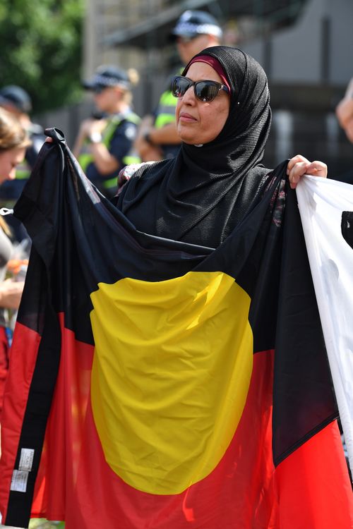 People attending the rallies, which are being held in cities around the country, wore traditional face paint and held up the Indigenous flag (AAP).