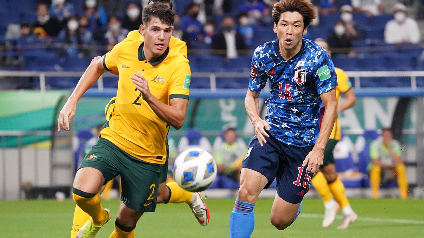 Fran Karacic of Australia and Yuya Osako of Japan compete for the ball