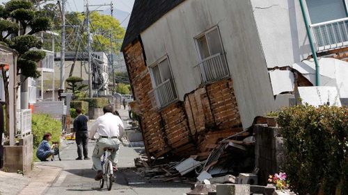 A collapsed house on a street in Mashiki town after the 6.2 quake. (AAP)