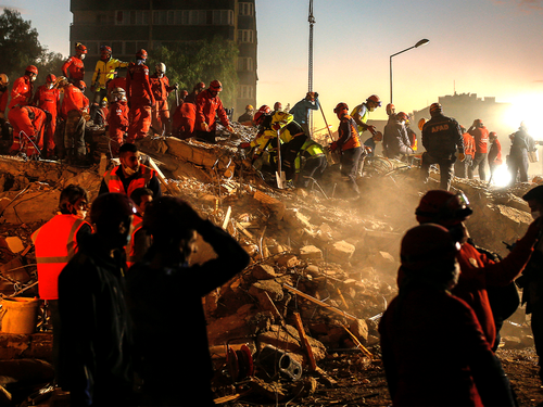Members of rescue services search for survivors in the debris of a collapsed building in Izmir, Turkey, Monday, Nov. 2, 2020. In scenes that captured Turkey's emotional roller-coaster after a deadly earthquake, rescue workers dug two girls out alive Monday from the rubble of collapsed apartment buildings three days after the region was jolted by quake that killed scores of people. Close to a thousand people were injured.