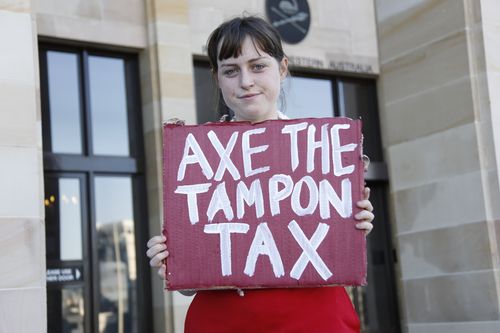 A protester holds up a sign at a rally outside Parliament House in Perth in 2015. (AAP)