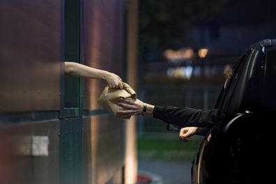 Customer Receiving Food at Drive Thru.