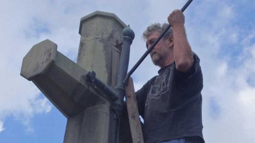 Men charged after removing sword from cross at war memorial