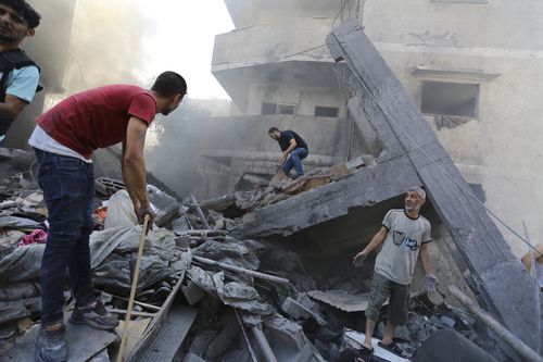 Palestinians look for survivors after Israeli airstrikes in Gaza City, Gaza Strip, Wednesday, Oct. 18, 2023. 