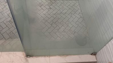 Glass shower screen before cleaning with citric acid.