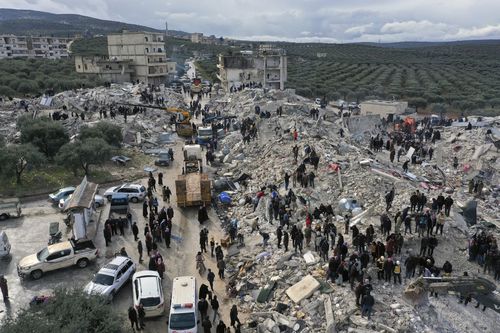 Civil defence workers and residents search through the rubble of collapsed buildings in the town of Harem near the Turkish border, Idlib province, Syria, Monday, Feb. 6, 2023 