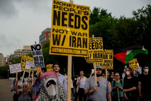 Demonstrators hold signs during a protest against war with Iran outside the White House in Washington, DC, US, on Wednesday, June 18, 2025. President Donald Trump concluded a meeting Wednesday with top advisers as he weighed whether to plunge the US into the ongoing war between Israel and Iran, but the White House offered few clues about whether he had decided to join the offensive aimed at destroying Tehrans nuclear program. Photographer: Kent Nishimura/Bloomberg