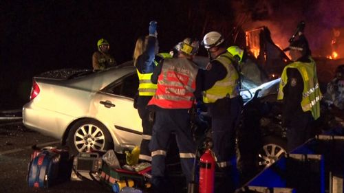 A driver is fighting for his life after he became trapped in his car following a fiery collision with a semi-trailer in the Blue Mountains.