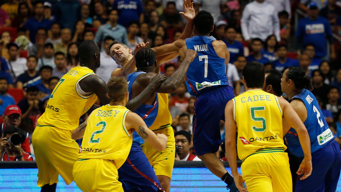 The Philippines' Jason William, (centre), jumps to hit Australia's Daniel Kickert (centre left) as others rush to break the brawl during the FIBA World Cup Qualifier between Australia and Philippines.