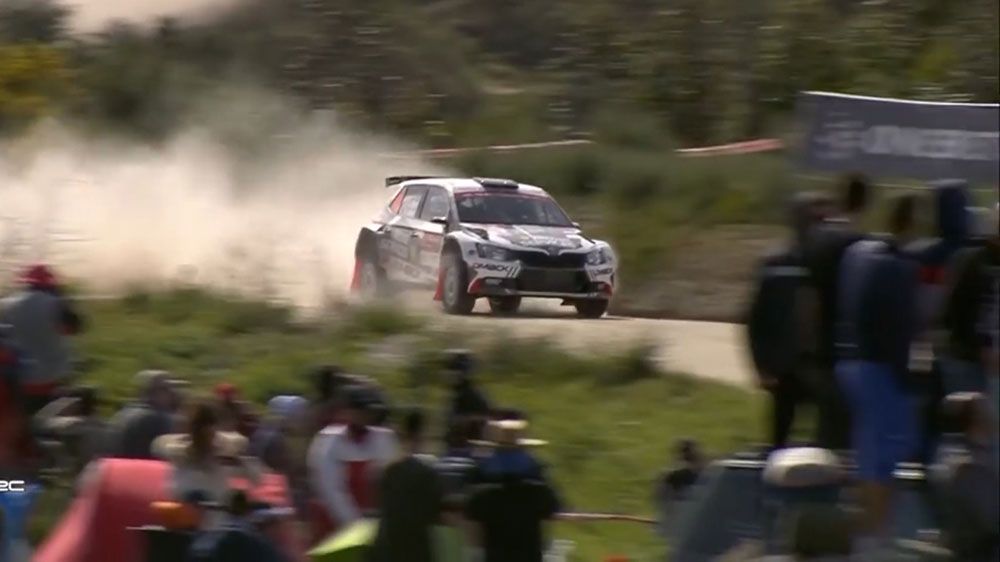 Rally car somersaults in the air at World Rally Championships