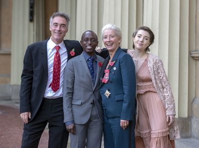 LONDON, ENGLAND - NOVEMBER 7:  Actress Emma Thompson, with her husband Greg Wise and children Gaia Wise and Tindy Agaba, leaves Buckingham Palace after she received her damehood at an Investiture ceremony on November 7, 2018 in London, England. Ms Thompson, 59, received the accolade in recognition of her services to drama. (Photo by Steve Parsons - WPA Pool/Getty Images)