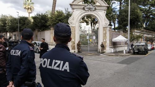 Police officers stand front the entrance of the Apostolic Nunciature in via Po in Rome.