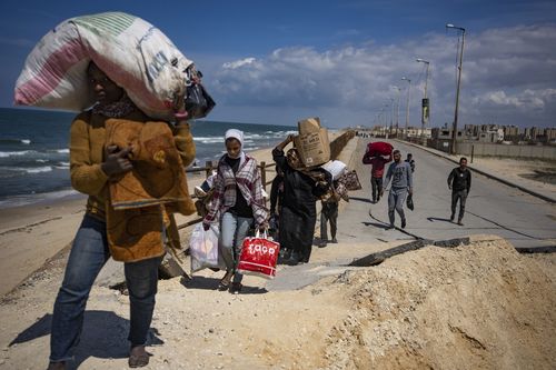 Palestinians flee Gaza City to the southern Gaza Strip, in Wadi Gaza, Monday, March 25, 2024
